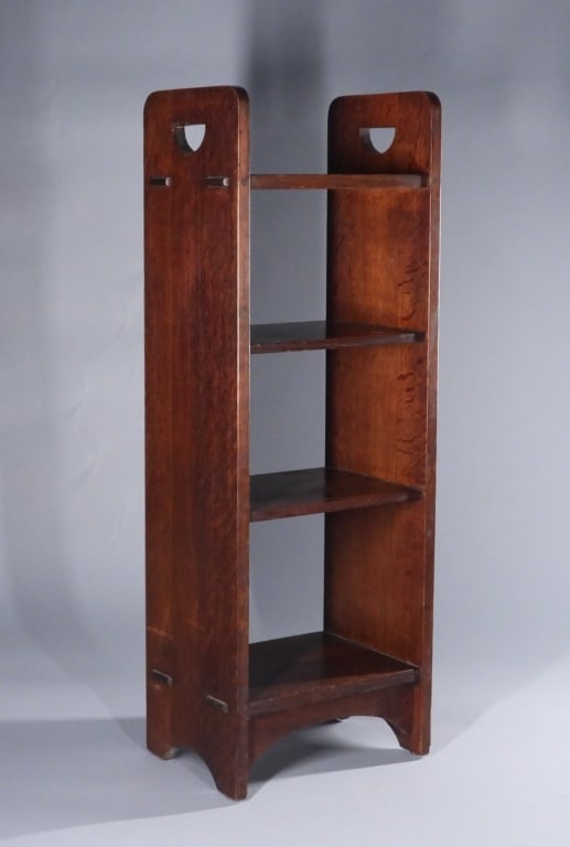Gustav Stickley Craftsman No. 79 Oak Magazine Rack: New York, Wisconsin,1858-1942 Oak wood four shelf magazine rack with "D" cut out handles. Stickley was a leading spokesperson for the American Craftsman movement, beginning at 12 years old he received