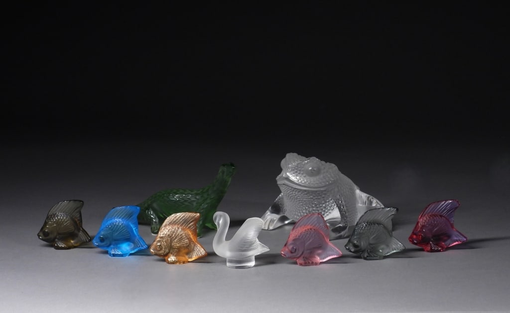 9PC Lalique Frosted Art Glass Animal Sculptures: France,20th Century Includes a rose, purple, blue, olive, smoke, and orange with gold glass fish, a colorless frosted glass swan, a green lizard, and a large colorless glass frog. Lalique was founded 