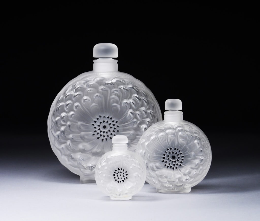 3PC Lalique Dahlia Frosted Glass Perfume Bottles: France,20th Century Includes three Dahlia perfume bottles, one small, one medium, and large store display sizes. Lalique was founded in 1888 by renowned jeweler and glassmaker Rene Lalique who got his