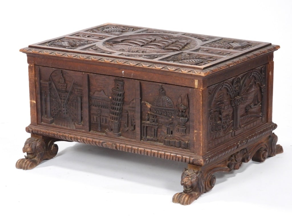 19C Italian Renaissance Revival Storage Box: Italy,19th Century Ornately carved chest depicting iconic national monuments of Italy throughout including the Leaning Tower of Pisa, Mt. Vesuvius, and others with rampant lion feet. Wood,15" t x 26 1