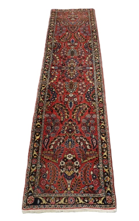Persian Sarouk Rug Carpet Runner: Middle East,20th Century Blue, yellow, red, navy blue, pink, and tan botanical spandrel design over red field surrounded by botanical boarders. Wool,Approx. 11' 3" x 2' 6". From the collection of a We