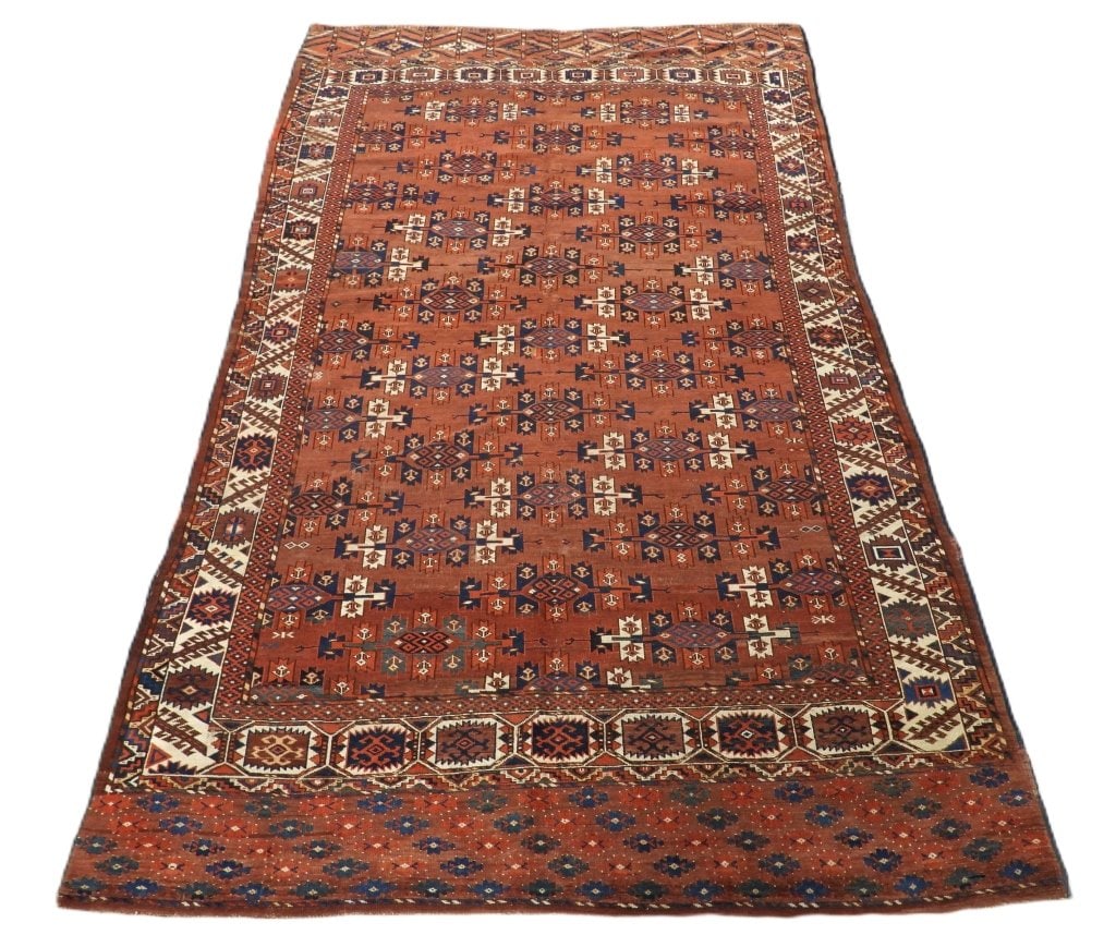 Antique Yomud Carpet Rug: Middle East,Early 20th Century Blue, navy blue, ivory, and red repeating pattern over red field surrounded by geometric boarders. Wool,Approx. 9' 5" x 5' 10". From the collection of a Chestnut Hill Es