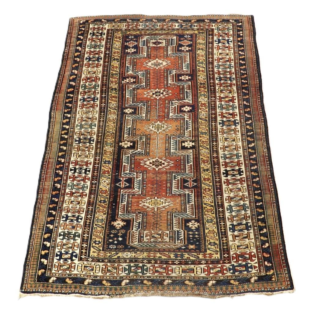 C1900 Keyhole Shirvan Carpet Rug: Middle East,Early 20th Century Yellow, blue, navy blue, rust, and ivory geometric patterned field surrounded by numerous geometric boarders. Wool,Approx. 5' x 3' 9". From the collection of a Chestnut 