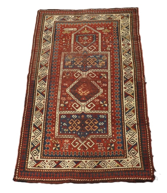 C1900 Caucasian Prayer Carpet Rug: Caucuses,Circa 1900 Yellow, red, blue, and ivory geometric pattern over red field surrounded by geometric boarders. Wool,Approx. 4' 10" x 3'. From the collection of a Chestnut Hill Estate.