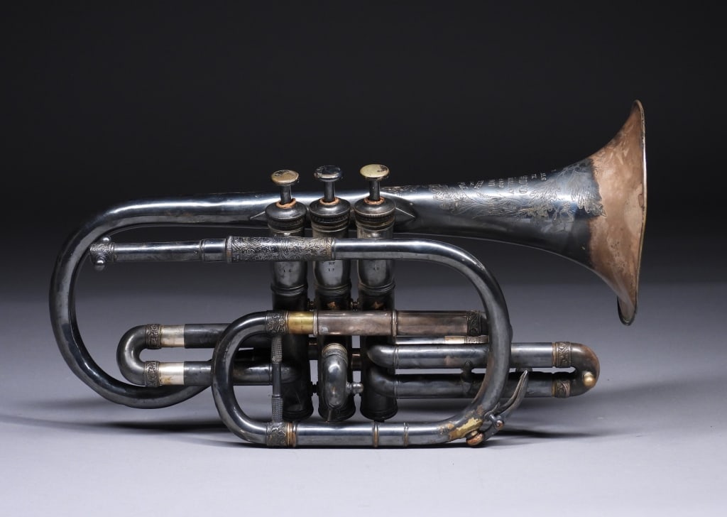 Charles Missenharter Silver Plated Cornet: United States,Circa 1880 Silver plated brass cornet with incised leaf and ribbon bell embellishment with vine detailing throughout. Missenharter first began to produce cornets in 1874 in New York with