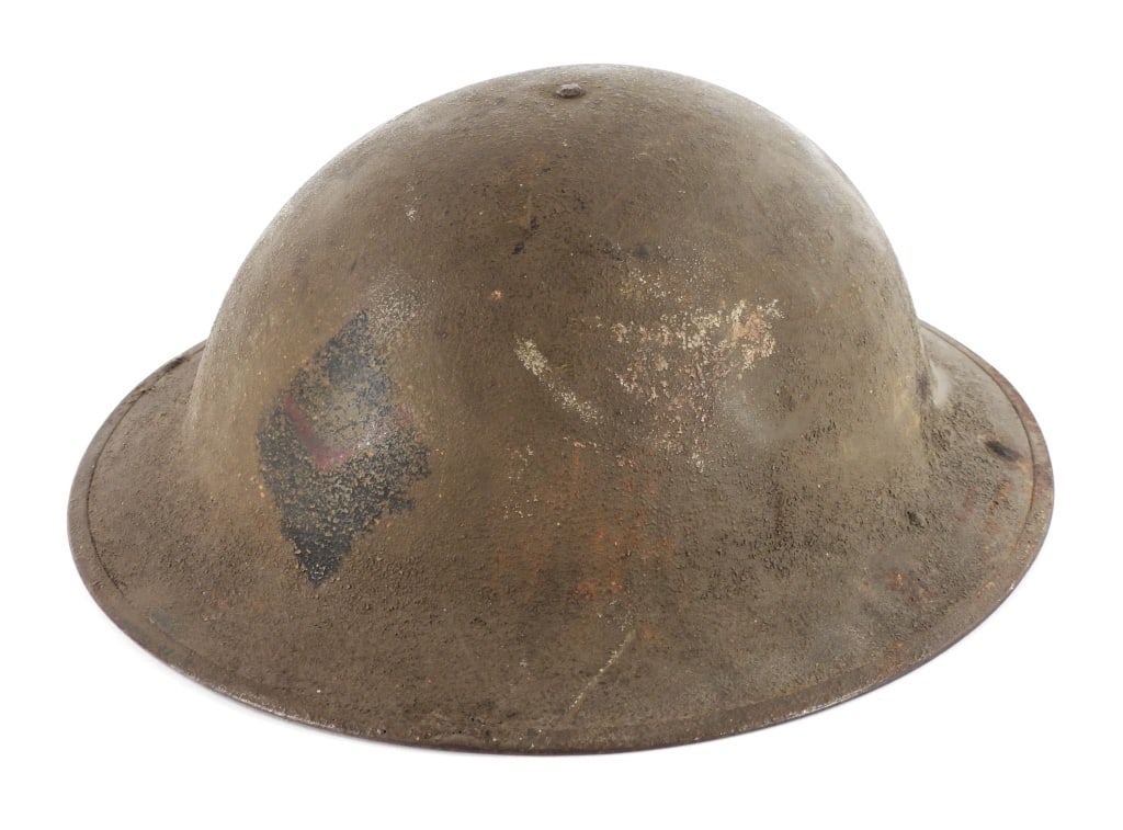 WWI 5th Marine Headquarters Helmet: United States Green-painted helmet with a blue diamond and red "V" painted on the front, marked on the underside of the rim "5 USMC HQ", with a liner and chinstrap.