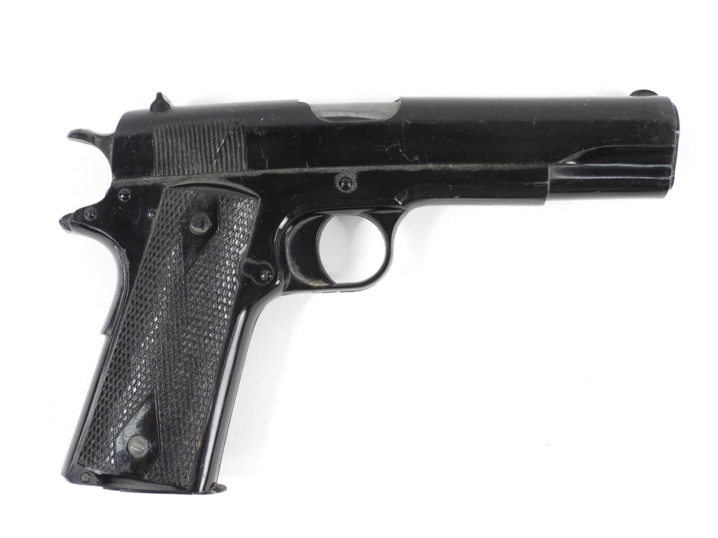 U.S. Navy Colt Model 1911 Dummy Training Pistol: United States Black-coated Colt Model 1911 dummy gun filled with lead for weight, marked on the bottom of the butt "U.S. NAVY". Overall lg. 8 1/4".