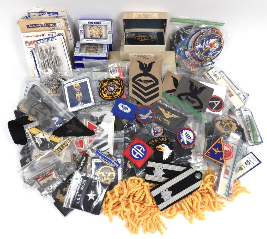 Large Group of U.S. Military Insignia: United States Large group of military insignia including patches, rank badges, ribbon bars, and other miscellaneous insignia.
