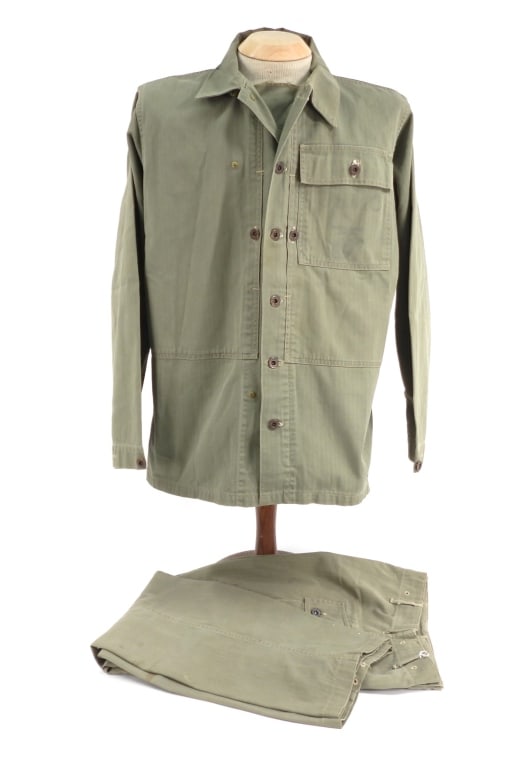 WWII USMC Modified P-44 HBT Tunic & Trousers: United States C. 1944-45 A P-44 HBT jacket with a pocket flap on the left breast, "USMC" and an eagle, globe, and anchor on the pocket bag, and metal "U.S. MARINE CORPS" marked buttons; and a pair of 