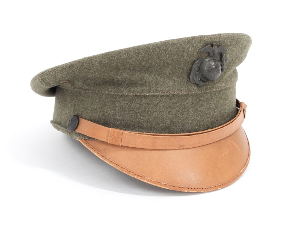 WWI-era USMC Bell Crown Enlisted Visor Cap: United States C. 1913 Green twilled wool cap body, screw back eagle, globe, and anchor insignia, brown leather chinstrap, brown-painted U.S.M.C. cuff-size buttons, a brown bound edge visor, brown leat