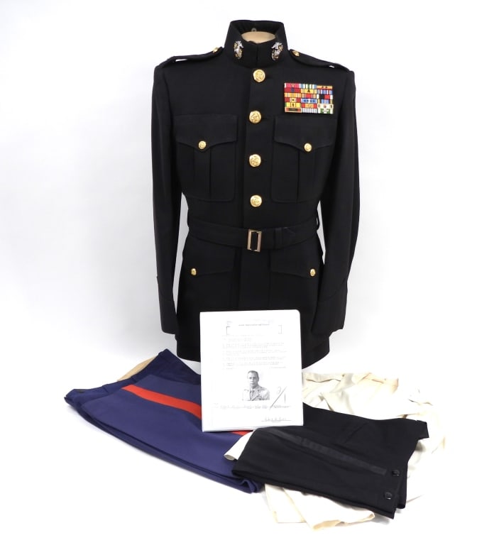 USMC Uniforms of Col. Robert H. Piehl: United States White mess dress jacket and black trousers, a dark blue dress tunic with silver eagle, globe, and anchor insignia on the collar, Colonel's insignia on the epaulets, brass U.S. Marine Cor