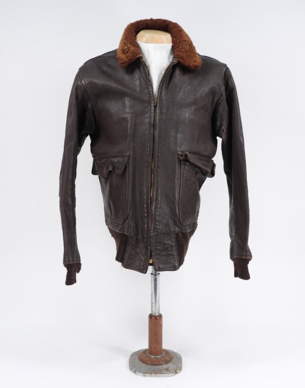 U.S. Navy M422A G-1 Flight Jacket: United States Brown leather flight jacket with light paint stencil on the back marked "VO-5/LIGHT..../XO" with the rest undecipherable, brown fur collar, brown wool cuffs and waistband, a worn label s