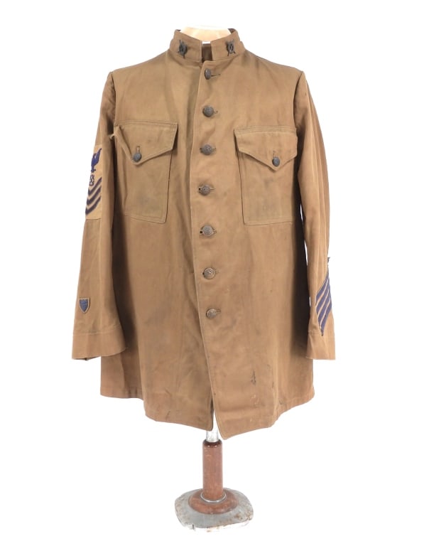 Pre-WWI Cotton U.S. Coast Guard Surfman's Tunic: United States C. 1914 Light brown cotton drill tunic, crossed oars over a life ring surfman insignia on each collar, rank insignia and Coast Guard shield on the right sleeve, brown-painted U.S. Coast 