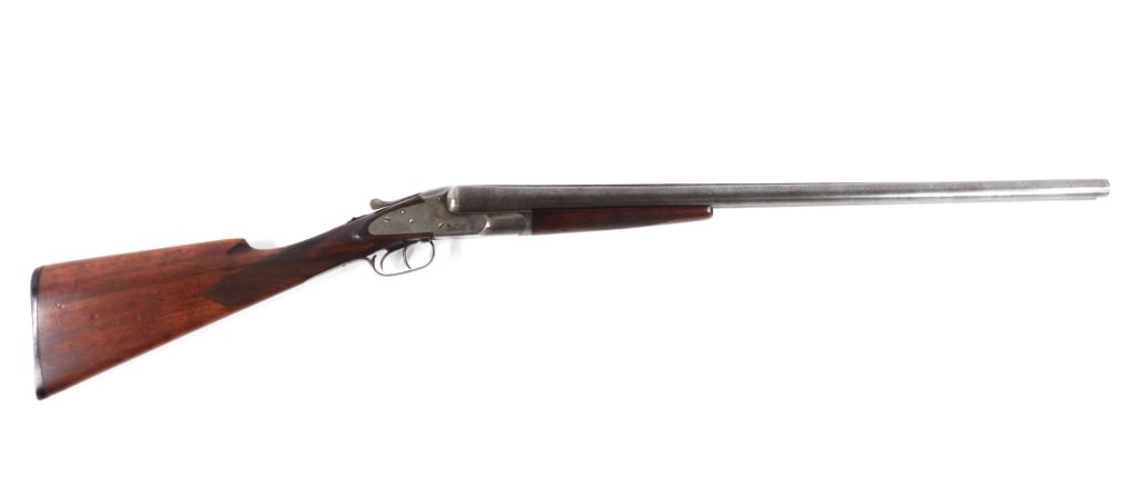 Baker Gun Co. Side-by-Side Shotgun: United States 12 gauge, serial number 102462, walnut stock with a checkered wrist and forend, marked on the left side of the receiver "BATAVIA BRUSH", marked on the top of the barrel "BAKER GUN CO.", 