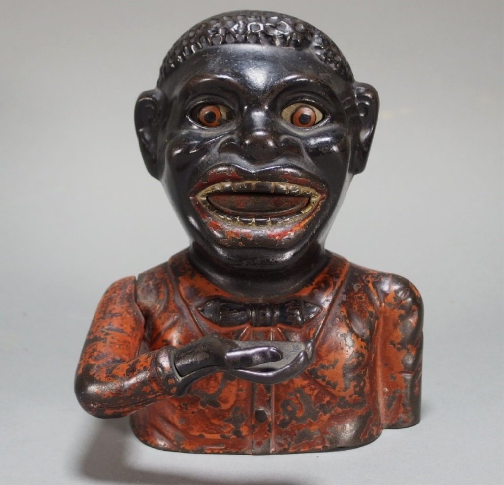Cast Iron Jolly Nigger Mechanical Bank: UNITED STATES, 20TH CENTURYCast iron "Jolly Nigger" bank. Dimensions:6 1/2" tall Notes:We Offer Shipping! Provenance: