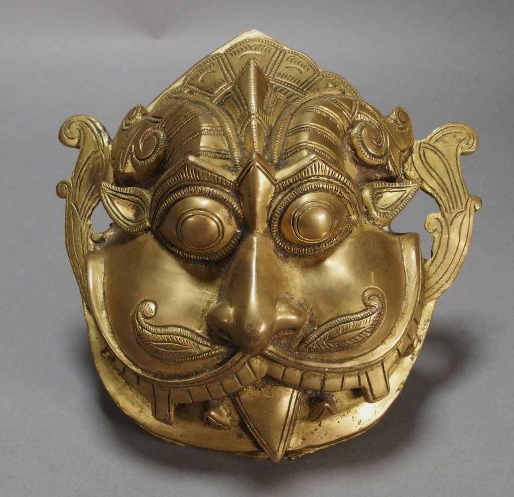 Indian Bronze Kala Mask Ex. Nancy Weiner Gallery: INDIA, 19-20TH CENTURYIndian bronze Kala mask with mustache and tongue hanging out. It bears a Nancy Weiner Gallery paper label. Dimensions:7 5/8" long by 3" deep. Notes:We Offer Shipping! Provenance: