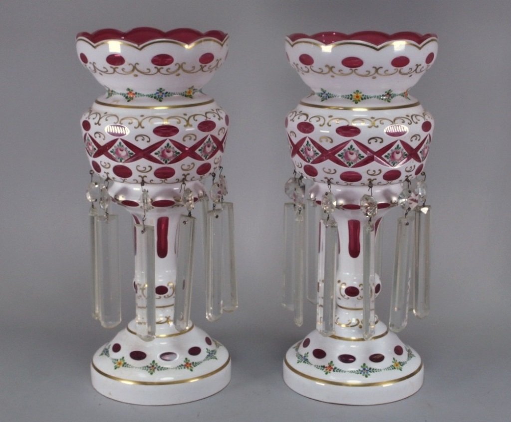 Bohemian Czech Cranberry White Cut Mantle Lusters: CZECH REPUBLIC, 20TH CENTURY A beautiful pare of Czechoslovakian cranberry and white mantle lusters. They are hand painted with a floral design and gold gilding throughout.