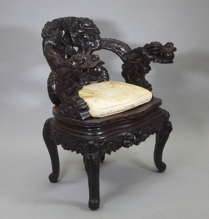 Asian Carved Wood Dragon Throne Chair: ASIA, 19-20TH CENTURY A finely carved wood dragon throne chair with stylized dragon in cloud back splat, supported on a flat top seat with Greek key border and large dragon arm rests.The chair sits at