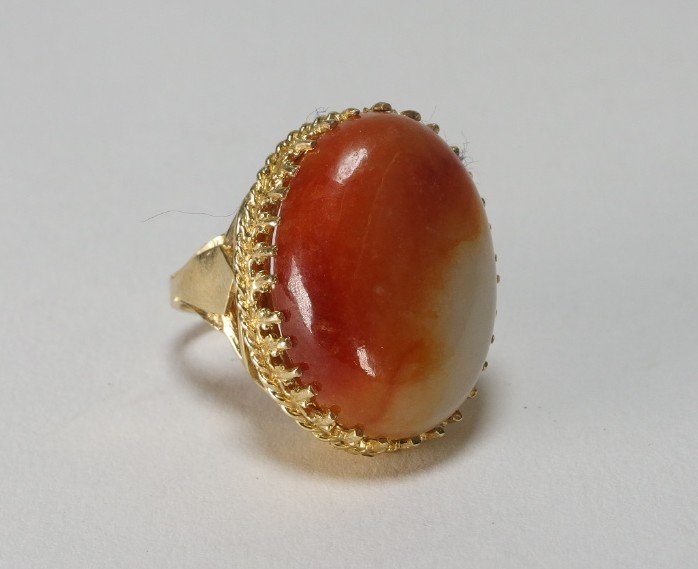 Chinese Carved Agate Hardstone 14KT Gold Ring: CHINA, 20th C.A well made large ring with beautiful colored agate cabochon. It is in a 14KT gold setting with open work sides. Very nice quality throughout.Stone measures 1" x 13/16", Size 6.5
