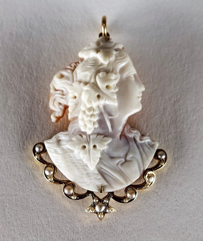 14 KT Yellow Gold Carved Cameo & Pearl Pendant: 14 KT Yellow Gold Carved Cameo & Pearl PendantA very unusual carved shell cameo depicting a lovely woman with grape leaves in her hair. The bottom adorned with star form with pearls. 1 5/8" long Prove