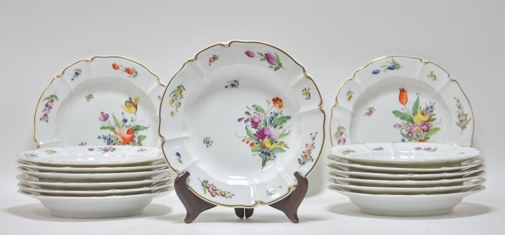 16 German Nymphenburg Porcelain Floral Soup Plates: GERMANY, LATE 19TH CENTURY A set of sixteen German Nymphenburg porcelain floral plates. Each plate is decorated with a unique hand painted floral decoration accented by a gilt rim. The reverse bears t