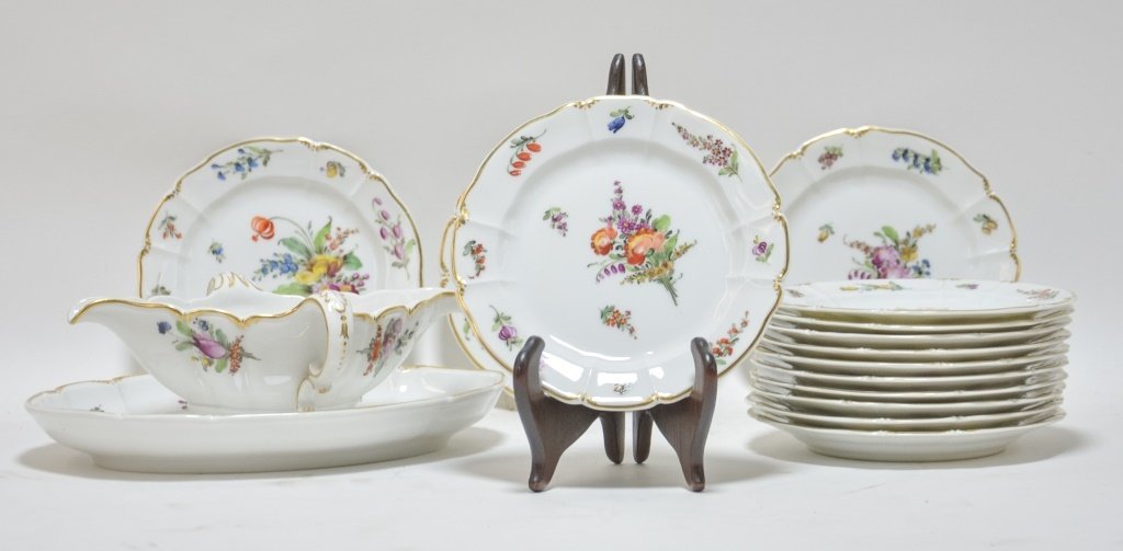 14 German Nymphenburg Porcelain Plates & Tureen: GERMANY, LATE 19TH CENTURY A set of fourteen German Nymphenburg porcelain floral plates and tureen. Each plate and tureen is decorated with a unique hand painted floral decoration accented by a gilt r