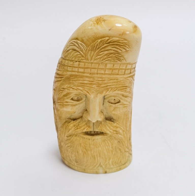 Antique Carved Sailor Made Bearded Man Whale Tooth: UNITED STATES, 19TH CENTURY Antique C.1880 carved sailor-made whale tooth depicting a man with a full beard. On his forehead a band of squares in a fence like form with palm tree, deeply carved with g