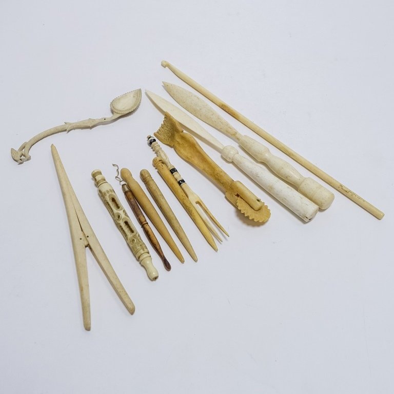 12 Whale Bone Carvings Bodkins Crimper Stretcher: UNITED STATES, 19TH CENTURY A lot of twelve vintage carved whale bone whimsy's including: bodkins, pie crimper, glove stretcher, intricately carved spoon, letter openers, knitting needle and more, all