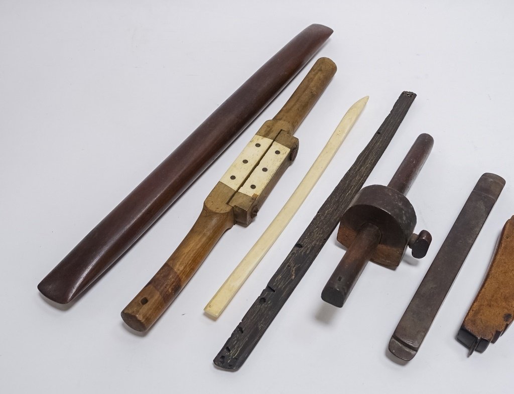 9 Antique Carved Wood & Bone Nautical Tools: UNITED STATES, 19-20TH CENTURY A lot of nine antique wood and bone nautical tools including a sailor-made spoke shave with bone insert, sail maker's seam rubber, fishing net mender, marking gauge, and