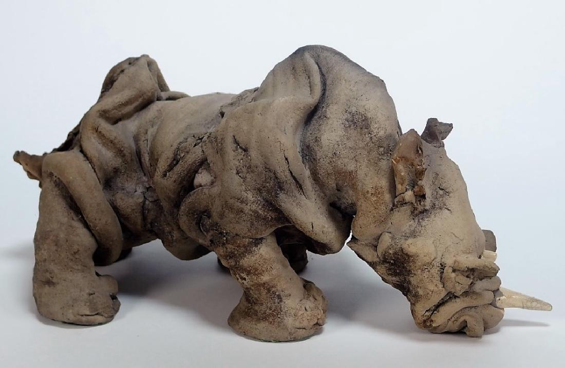 Patricia Simons Raku Fired Stoneware Rhinoceros: UNITED STATES, 20TH CENTURY A Raku fired stoneware and porcelain sculpture of a Rhinoceros by Patricia Uchill Simons. The work is signed and dated. Provenance: Purchased from RISD Alumni Auction, Octo