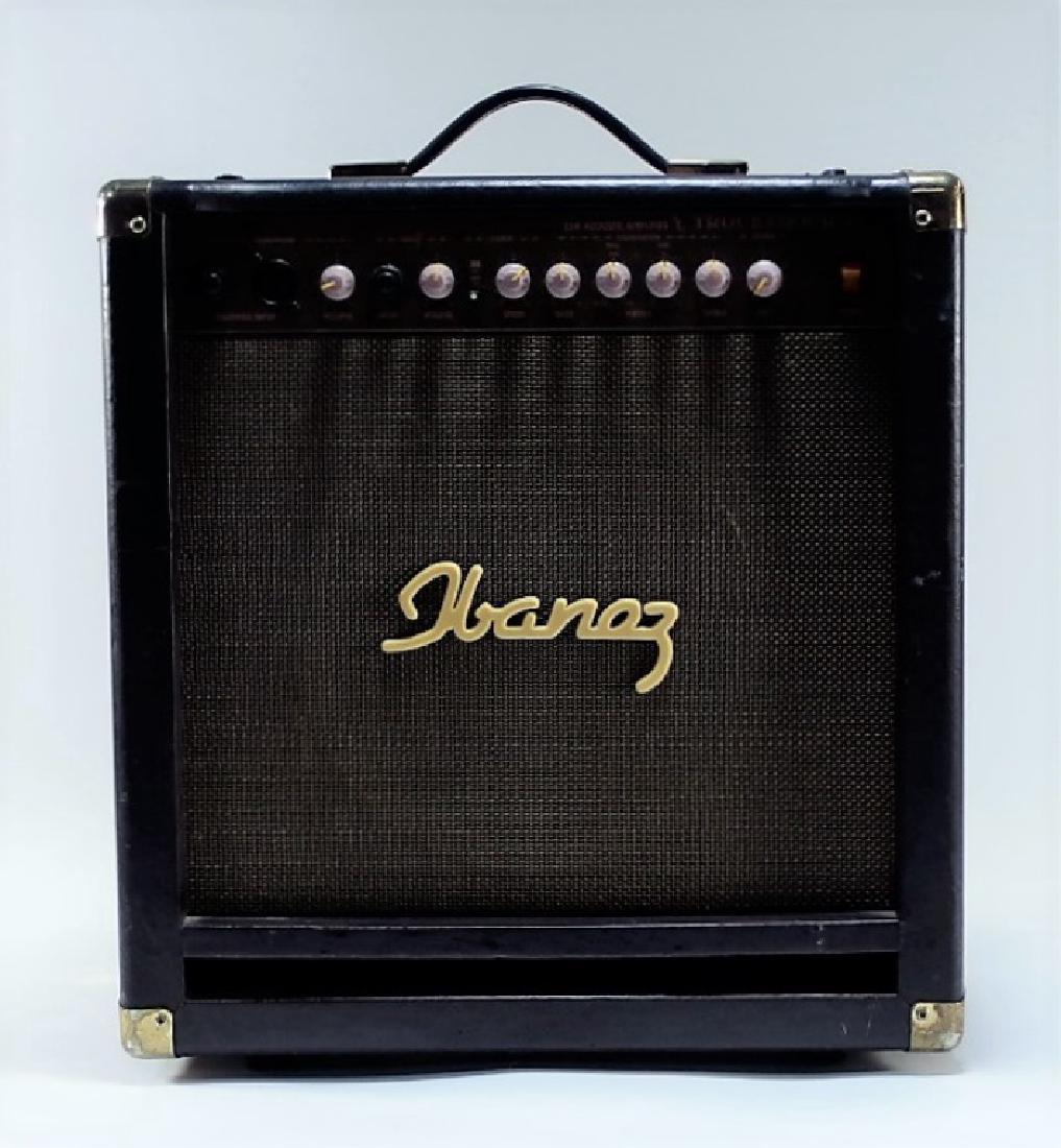 Ibanez 2A25 Troubadour Brown Gold Amplifier: CHINA, MODERN An Ibanez 2A25 Troubadour guitar/ voice amplifier. The amplifier features a brown Tolex covering with gold hardware and fasteners and can accommodate both guitar and voice input with adj