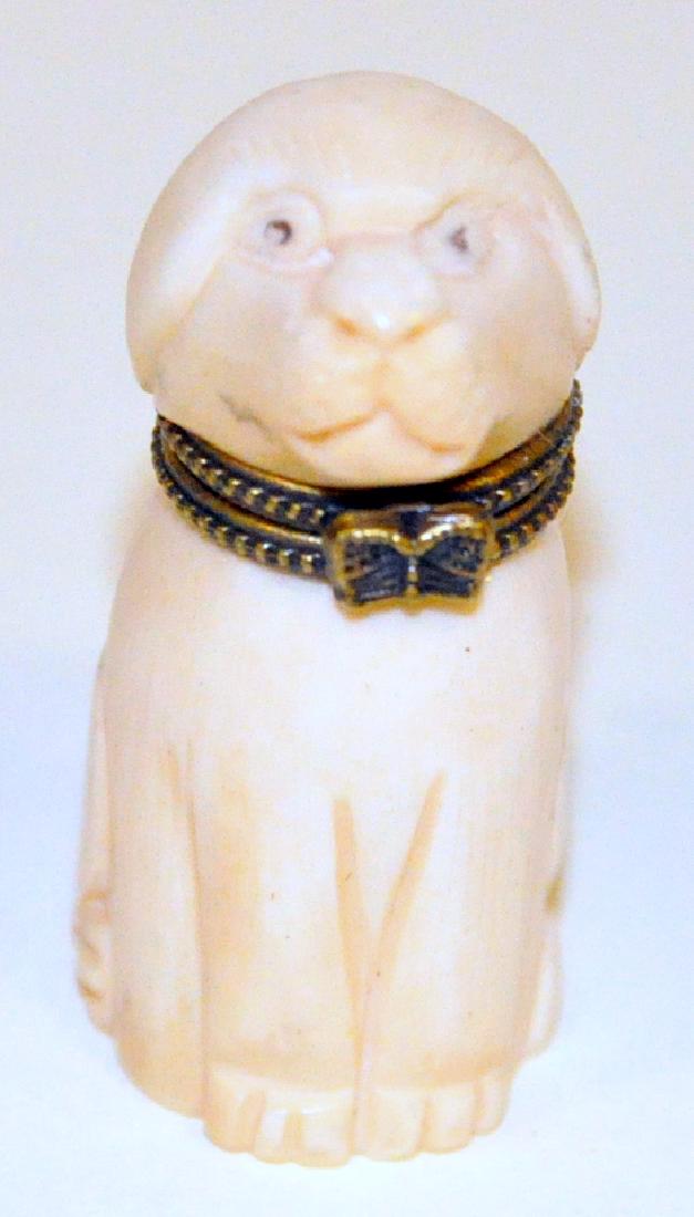 Dog carved bone box: Dog Hand carved bone -camel bone- box with head that lifts open on brass hinge to store small treasures . Great condition and carving - a unusual dog collectible. About 2 inches high.