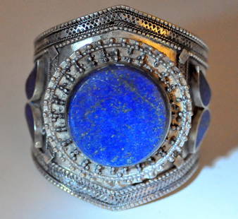 Lapis cuff bracelet Afghani: Large cabochon lapis cuff bracelet with 3 side stones - large central lapis cab in center with many gold flecks - about 1 1/3 inch center lapis . Bracelet is 3 inches wide at center.