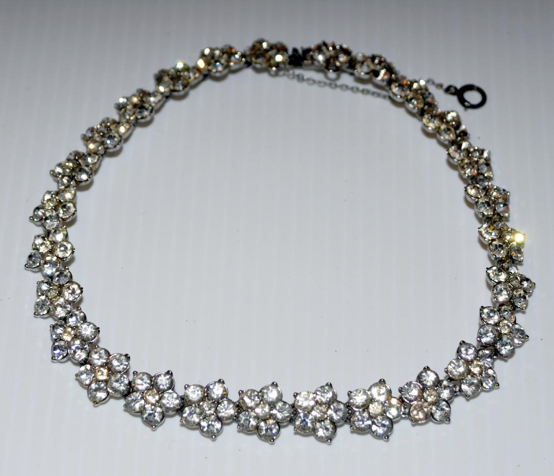 Rhinestone choker vintage flower pattern: Rhinestone choker with floral shape on beads- -safety catch -few stones not present but not noticeable for the most part. About 15 inches