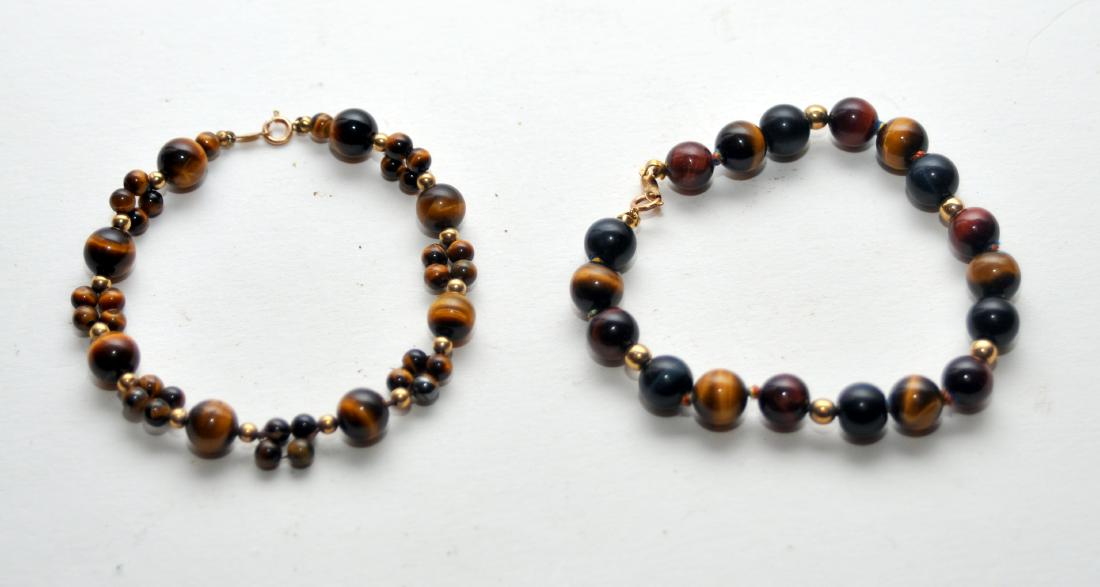 2 tiger eye 14k bracelets: 2 tiger eye bracelets with beads about 7 1/2 mm and 14k findings and balls - 2 different custom designed braclets in nice condition