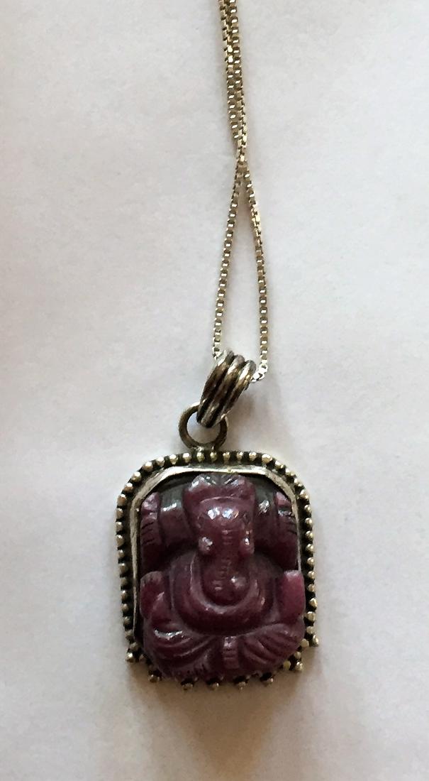 Ruby carved Ganesh pendant sterling chain: Hand carved natural Indian ruby designed and hand made into elephant god Ganesh with very nice detail and color- deep relief carving and beautifully bezel set into sterling setting and on box chain in