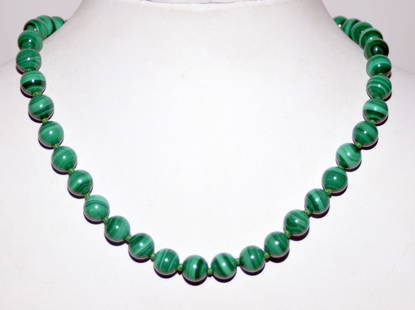 Malachite beads knotted necklace: Malachite beads approx. 10 mm size knotted on green silk and about 18 inches long.