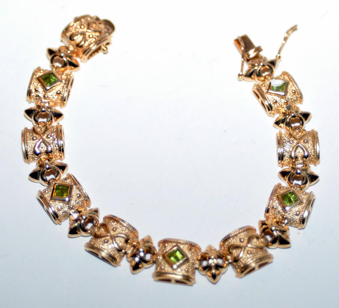 Vermeil bracelet peridot sterling: Vermeil bracelet with 5 colibri cut bezel set peridots hand set marked sterling - triple safety catch - approx. 7 3/4 inches long and 3/8 inch wide . 20 segments hand cast and polished .