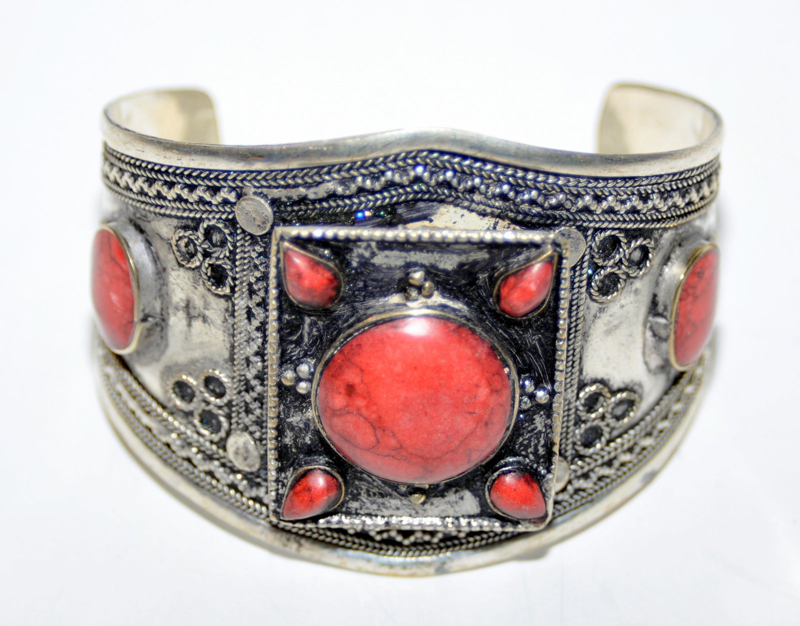Cuff bracelet Afghani tribal design: Cuff braclet possibly carnelian stones set into bracelet center red stone is bezel set - not sure what the stone is -about 2 1/2 inches across -