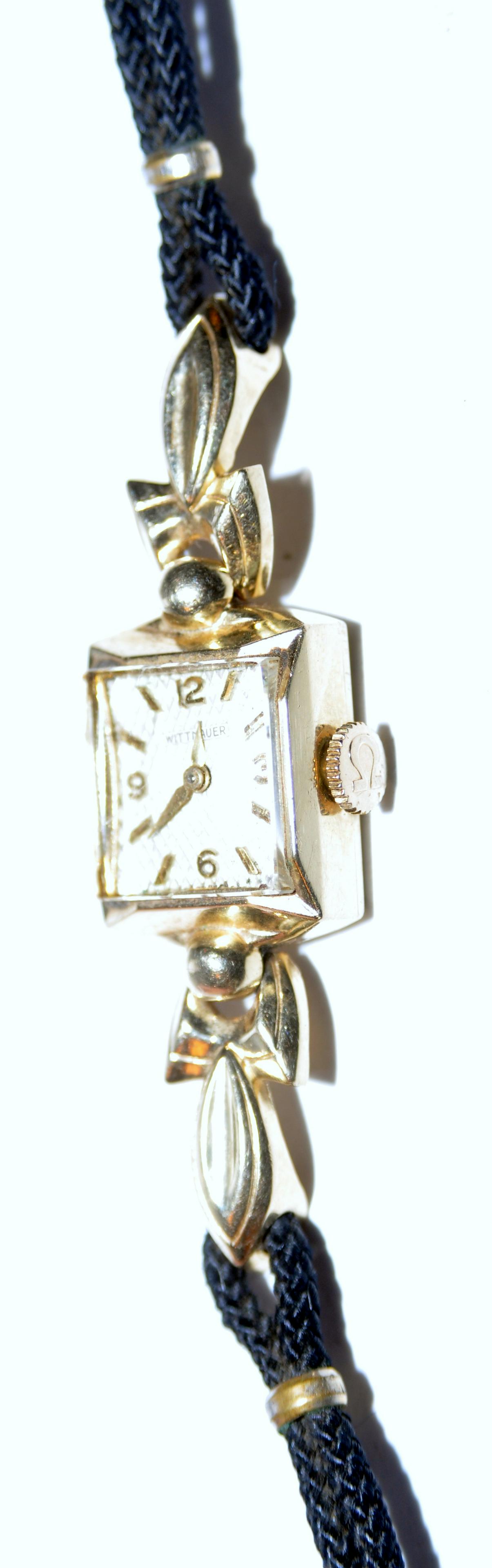 Vintage watch gold Wittnauer: Wittnauer square gold vintage wristwatch with square face and original band - marked 14k on back plate- face and crystal in fine condition - 2 inch gold head on original stretch black band