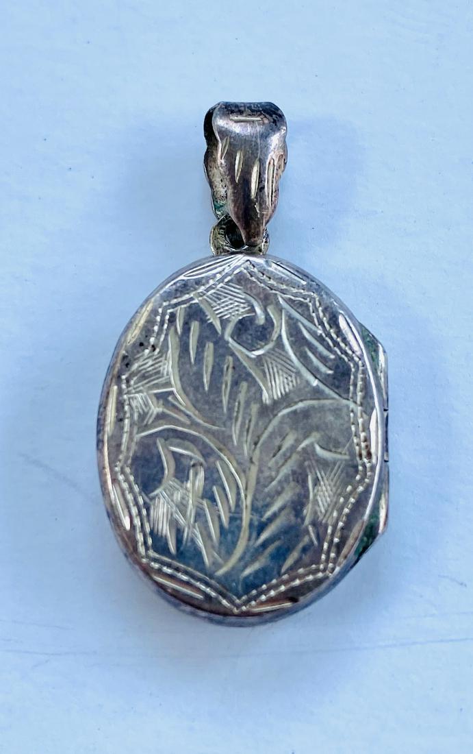 Vintage locket sterling: Vintage locket in nice condition about 1 inch diameter engraved on both sides.
