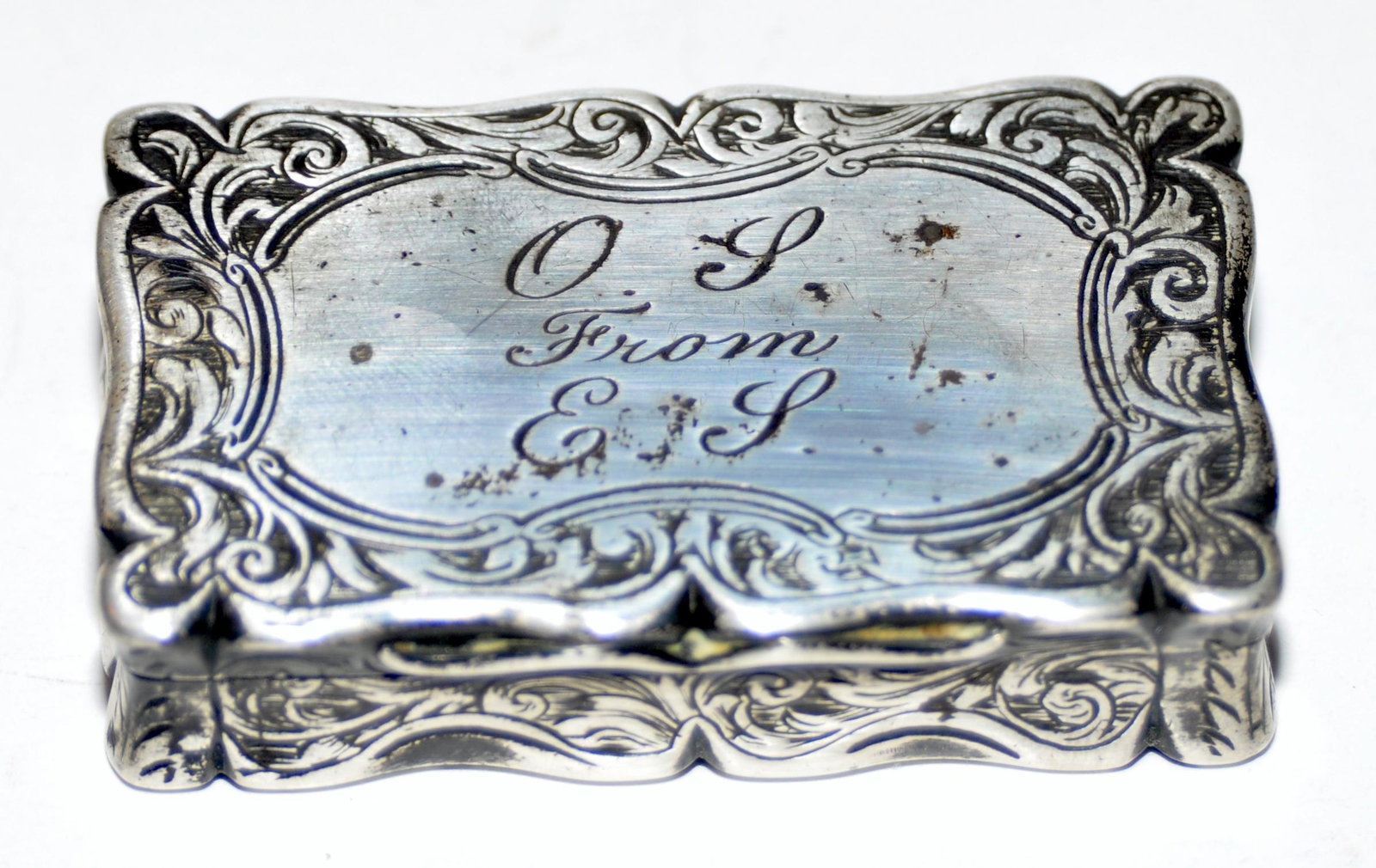 English sterling snuff box: English sterling snuff box fancy engraving with Birmingham mark. Heavily engraved on all sides - 19th c and beautifully inscribed on top with initials. Hallmarks inside showing lion and maker mark ES.