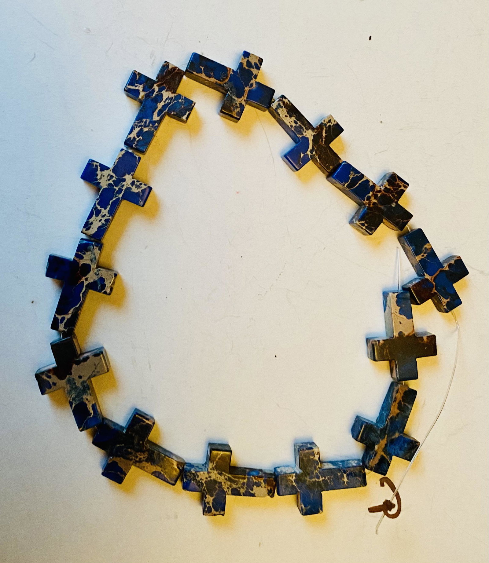 Sodalite crosses drilled 13: Collection of 13 sodalite crosses drilled each about 1 1/4 inches and in nice condition. - They are great for creating pendants or hanging on a display.