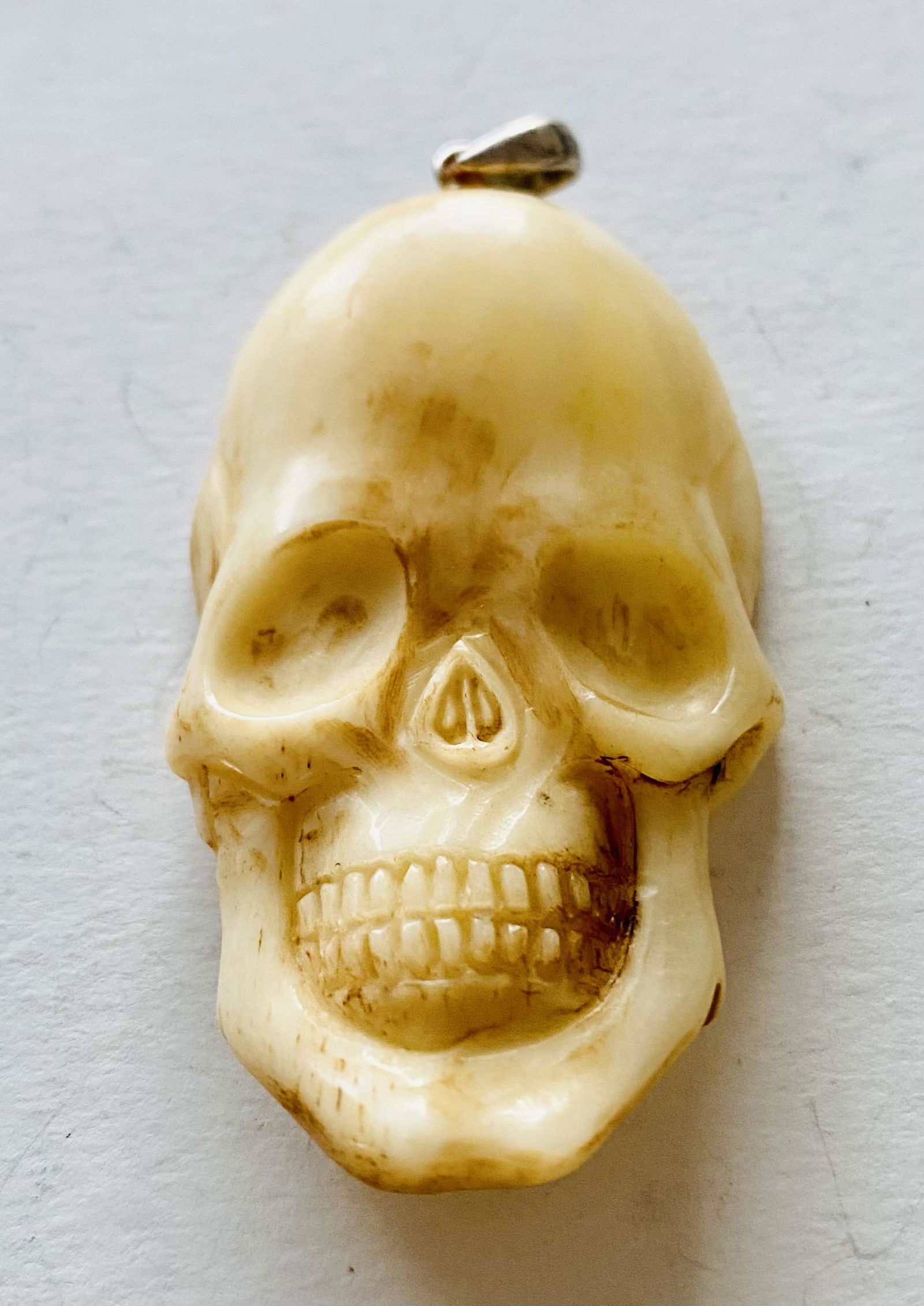 Skull bone carved face pendant: Skull bone face carved from cow bone into this custom pendant about 1 1/2 inches high and condition is nice.