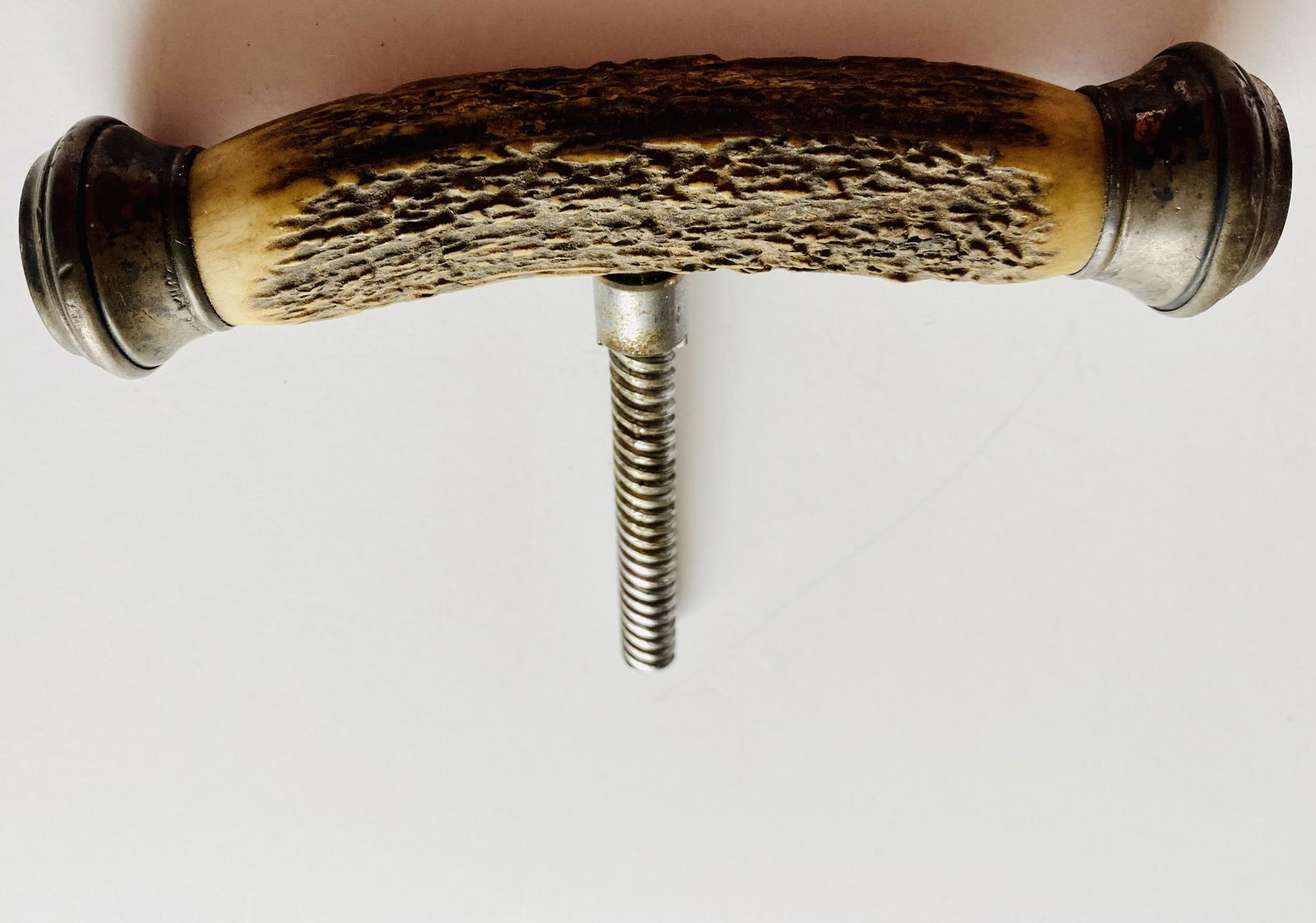 Stag handle with silver tone caps: Vintage stag horn handle with silver color caps on each end and large screw coming out of the middle for using possibly as a cane handle or handle for cork screw. Many ways to utilize his old handle.