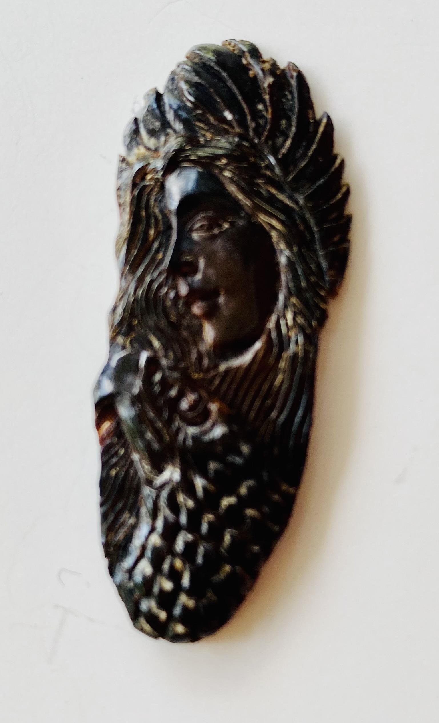 Fossil carved fetish woman: Fossil carved detailed fetish with woman in profile and animal underneath- could be mounted - beautifully done and about 2 inches