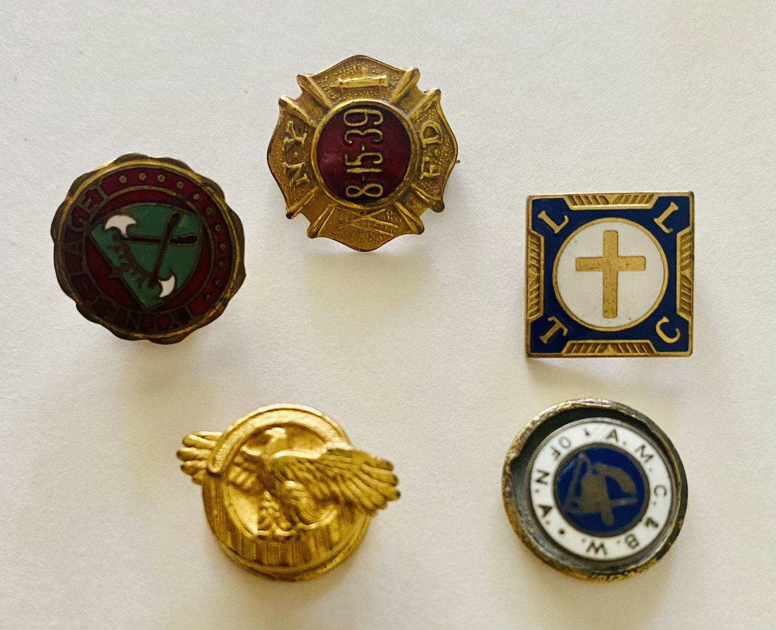 5 Old pins inc. NYC fire department: 5 old enameled and metal pins designed for collar or hats- all different- one is NYC fire department, one has cross anad religious -