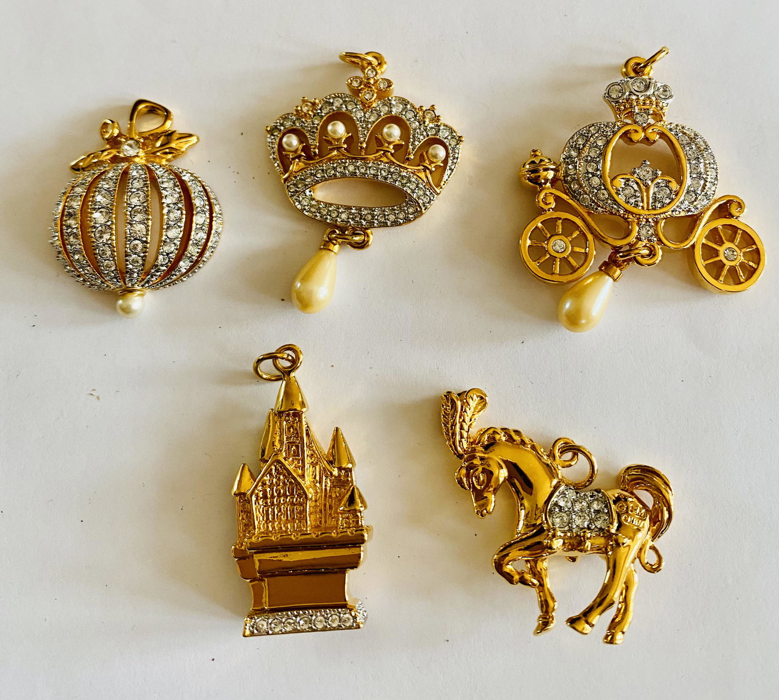 Franklin Mint signed pendants: Franklin Mint signed pendants with clear stones- pumpkin, crown, carriage, castle and horse in great condition - likely never used about 1 inch or slightly more each.