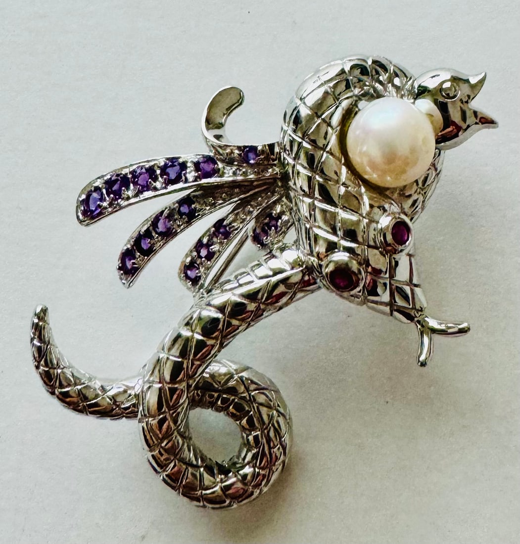 Sterling snake pearl pin: Sterling snake pin with ruby stones and pearl set into this unusual pin- ruby eyes in snake head and about 1 1/2 inches- excellent condition.