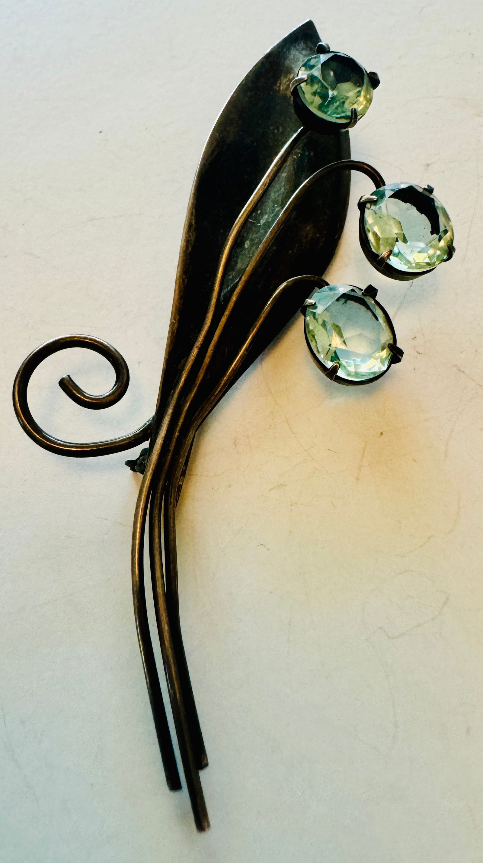 Coro vintage pin with blue stones: Signed Coro leaf long pin with 3 blue stones set in- possibly blue topaz -- really nice pin in beautiful condition.. Aboout 3-4 inches.